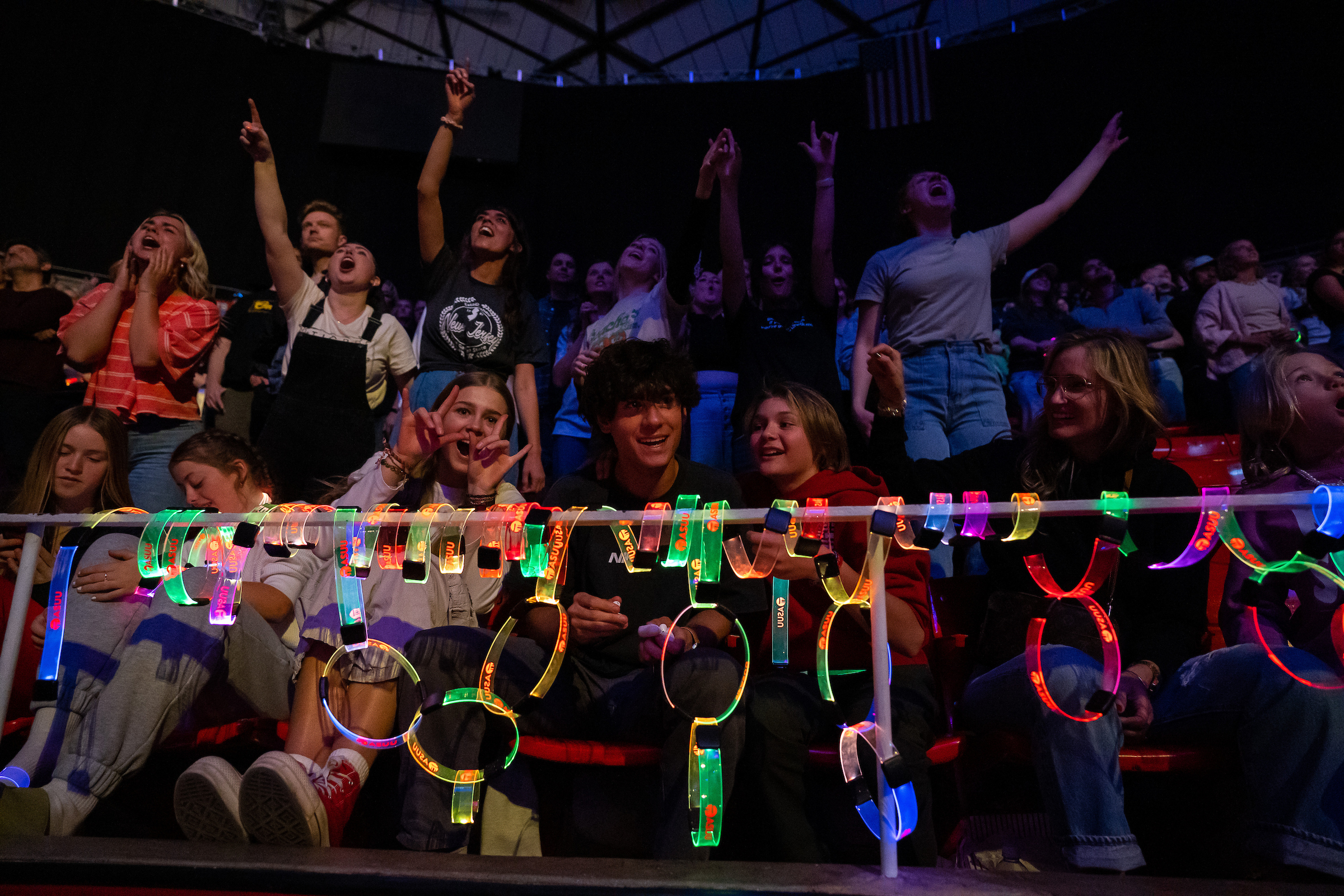 Students cheering at a neon lights event