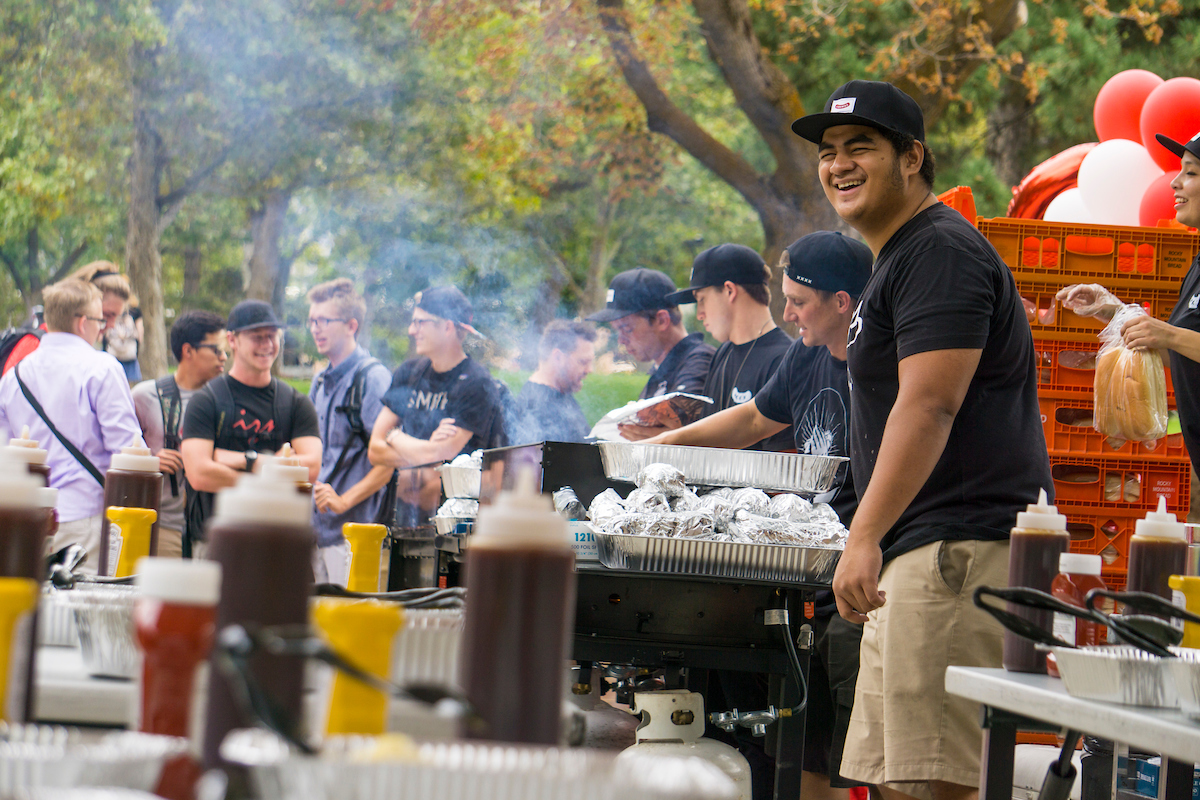 Students laughing and having fun at a BBQ event